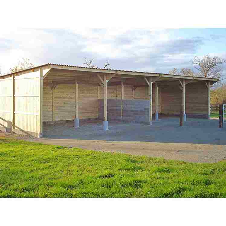 Hangar d'élevage pour chevaux en construction vu légèrement de profil.